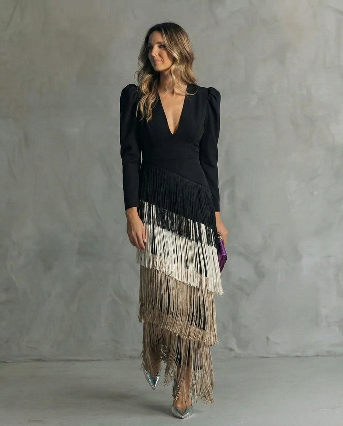 Model wearing the black dress with cream and beige fringe tiers, front view 5
