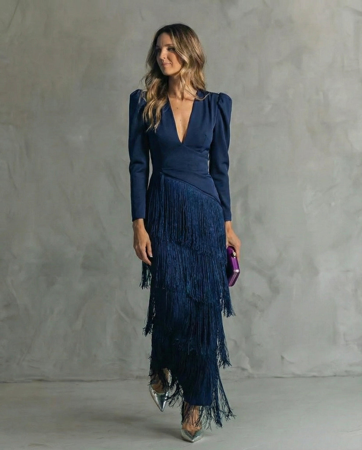 Model wearing the navy blue fringe dress with long sleeves and V-neck, front view 6