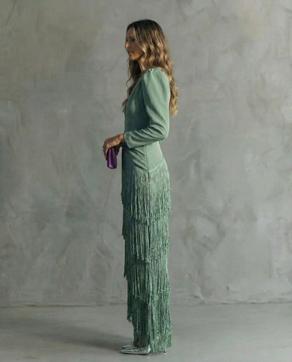 Side profile of the sage green dress, showing the cascading fringe tiers and long fitted sleeve 3
