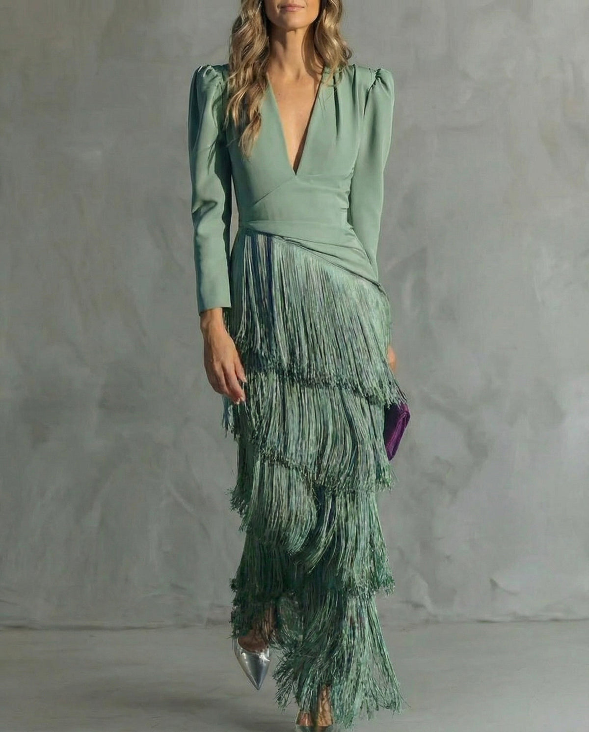 Model in the sage green tiered fringe dress, cropped front view showing the deep V-neck and puff shoulders 1
