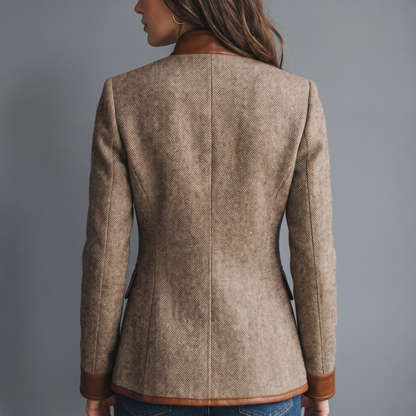 Back view of the jacket on a model, showing herringbone tweed, a centre back seam and tan trim at collar, cuffs and hem. 3