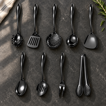 Nine black utensils in two rows on dark stone with a cloth and rosemary, including skimmer, wok turner, slotted spoon, fork and tongs. 29