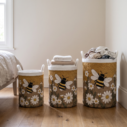 Three baskets in small, medium and large sizes lined up in a bedroom, holding folded towels and a heap of clothes. 4