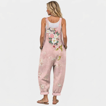 Back view of the overalls on a model, showing the same floral bouquet print across the back and straps. 4