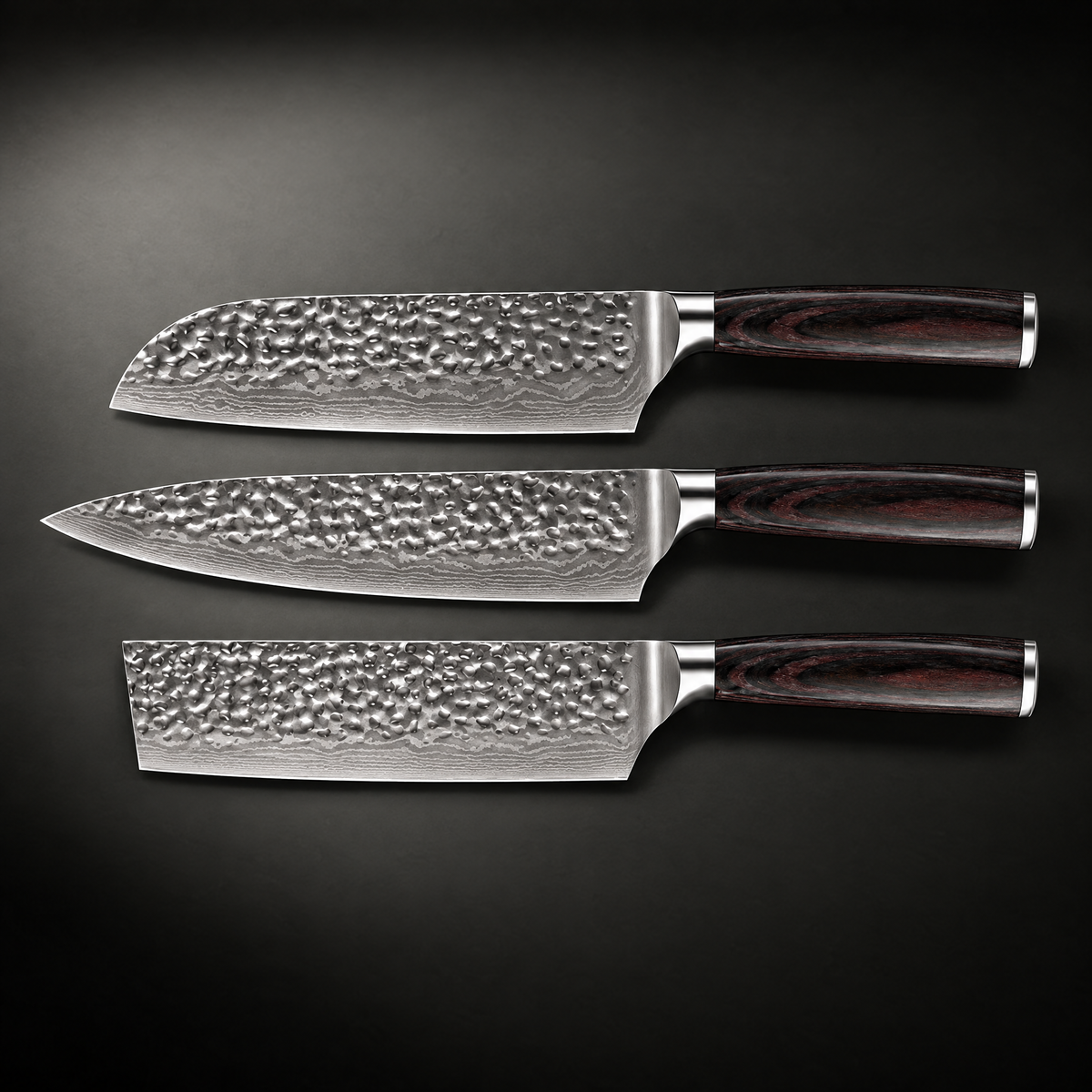 Flat lay of the three knives side by side, showing the hammered blade surfaces and wood handles 2
