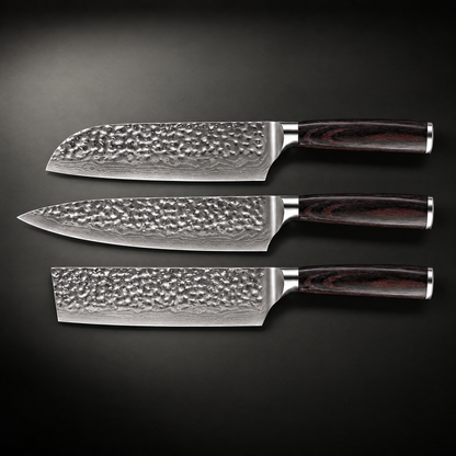 Flat lay of the three knives side by side, showing the hammered blade surfaces and wood handles 2