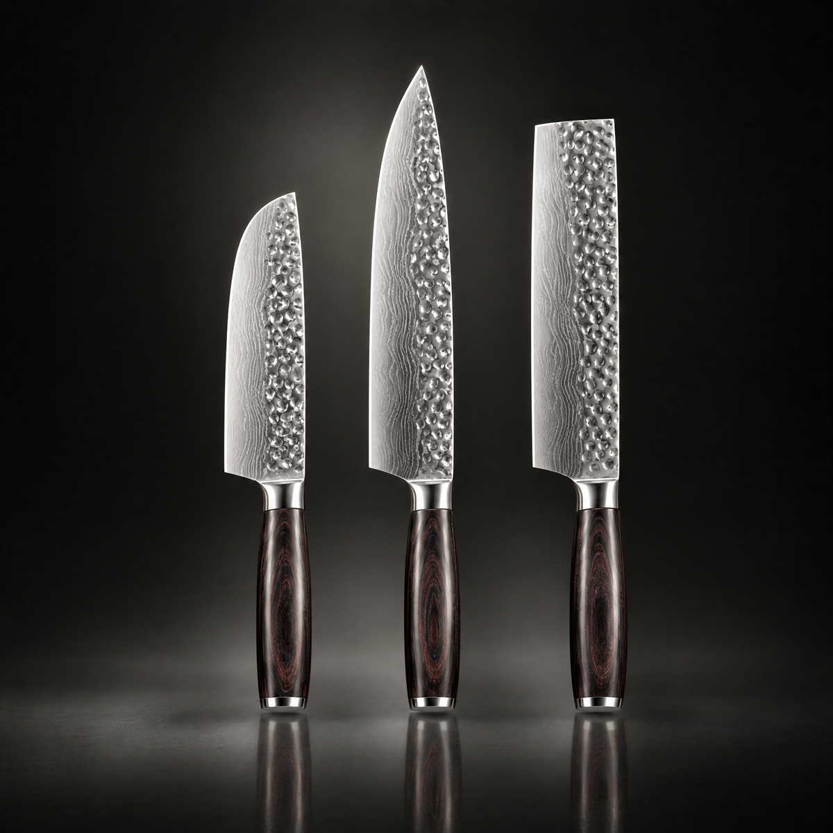 Three hammered-blade knives with dark wooden handles standing upright against a dark reflective background 1
