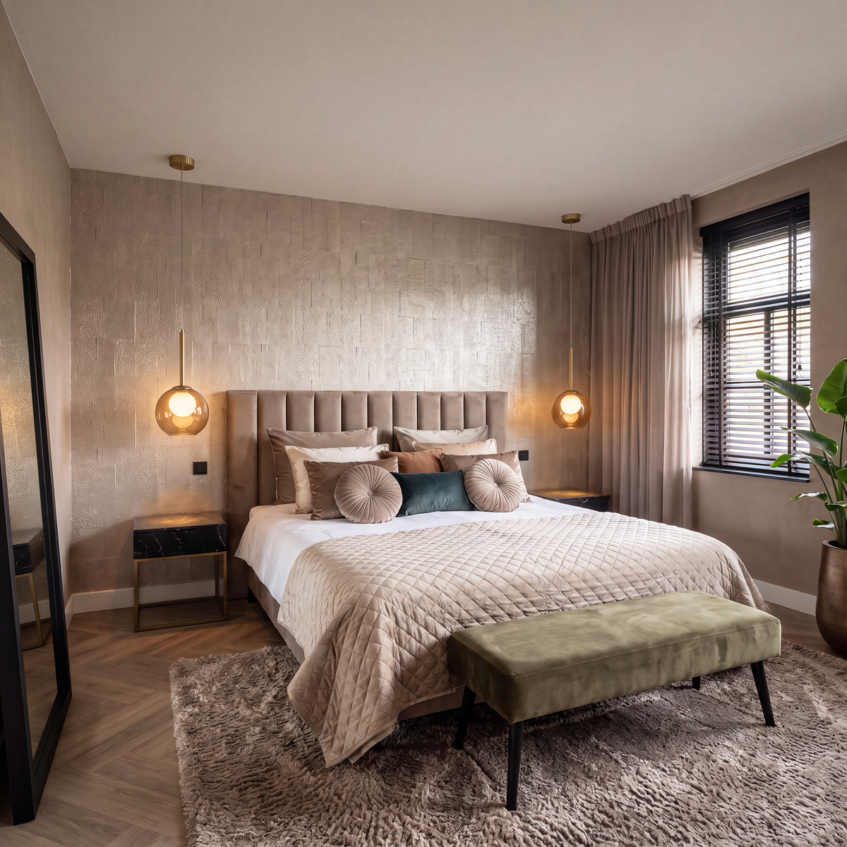 Two amber globe pendants with brass stems glowing as bedside lights either side of an upholstered bed 3