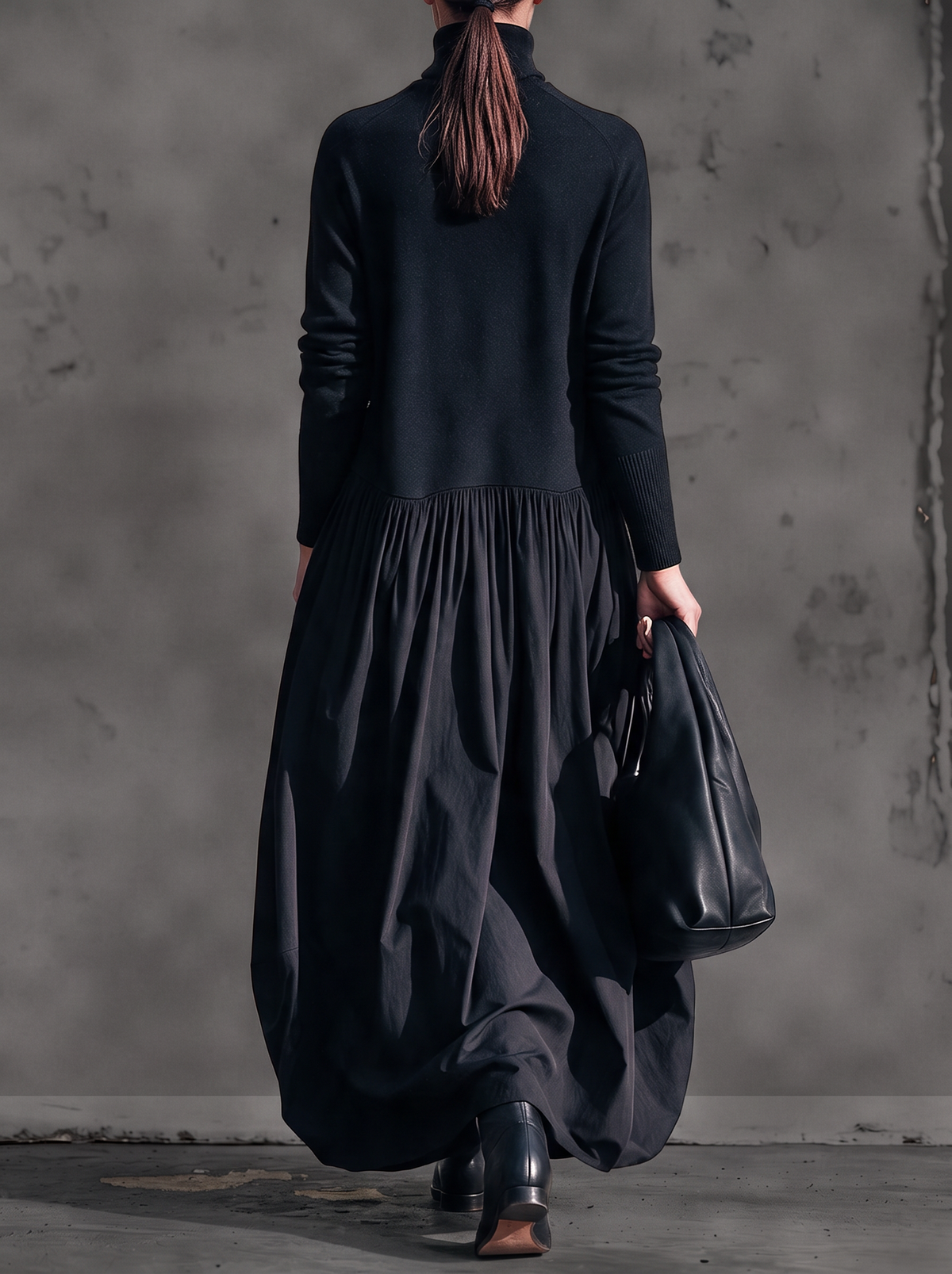 Back view of the black maxi dress, showing the plain mock-neck bodice and full gathered skirt 3