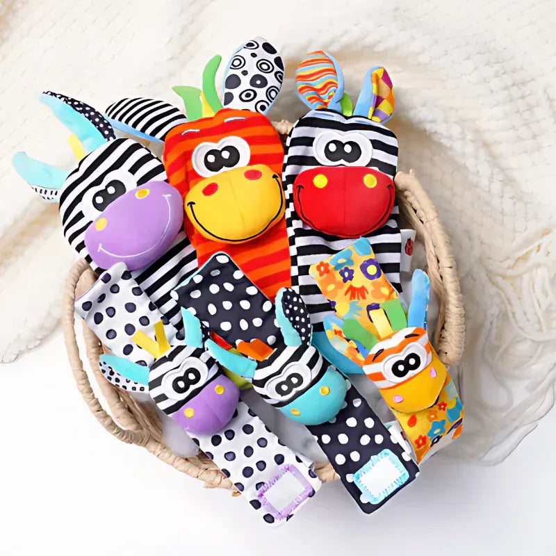 Wicker basket filled with zebra and giraffe rattle socks and wrist rattles in black-and-white, orange, purple and teal patterns. 9