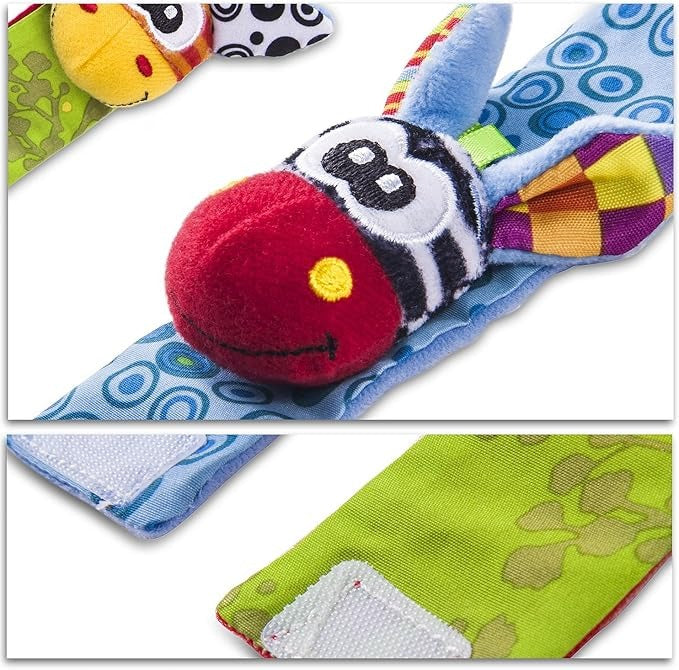 Close-up of a blue wrist rattle with a red-nosed zebra head, with the hook-and-loop fastening straps shown below. 10