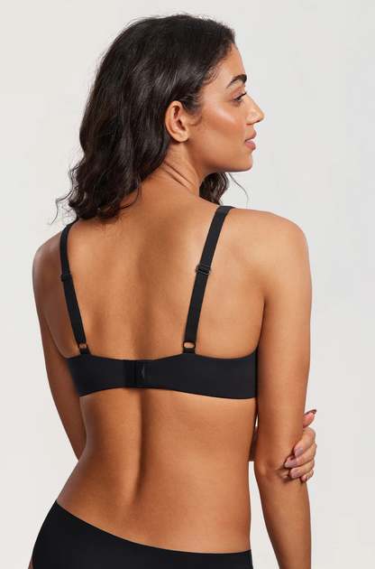 Back view of a model in the black bra, showing the adjustable straps, the hook-and-eye closure and a smooth band. 13