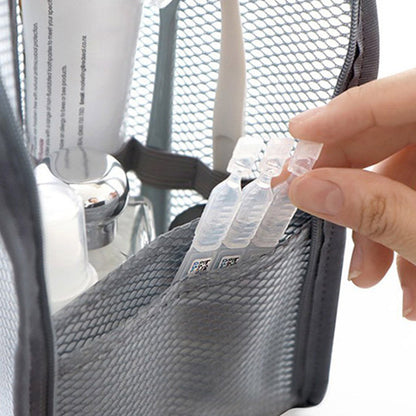Close-up of a hand pulling small liquid ampoules from the front mesh pocket of a grey pouch, with a toothpaste tube and bottles behind. 3