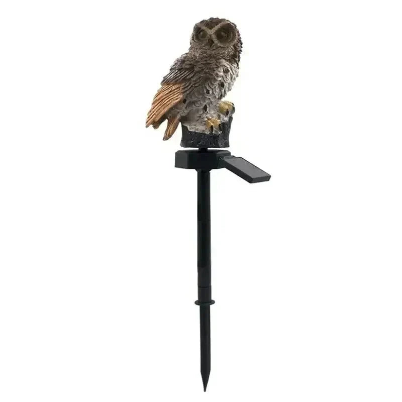 Brown owl version on its black stake with solar panel angled out, shown on a plain white background. 16