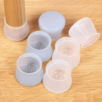 Six translucent silicone leg caps arranged on a wooden surface, with one fitted to a leg and small holes visible inside. 3