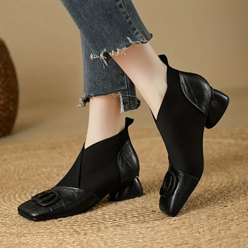 Pair of black knit-and-leather ankle boots with square toes and chunky heels, worn with frayed jeans 2