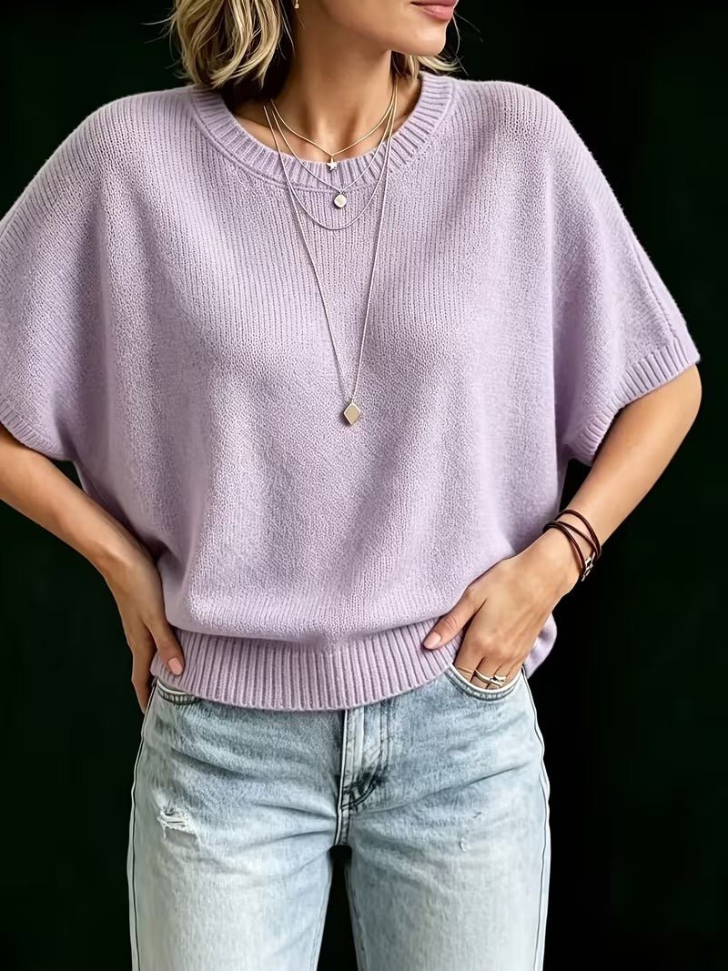 Lilac knit top shown from the front with hands on hips, highlighting the cropped length and short batwing sleeves. 11
