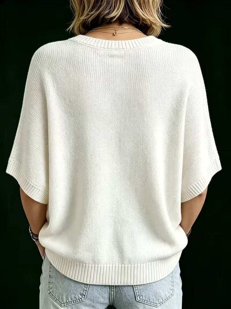 Back view of the cream knit top on a model, showing ribbed round neck, short batwing sleeves and curved hem. 25