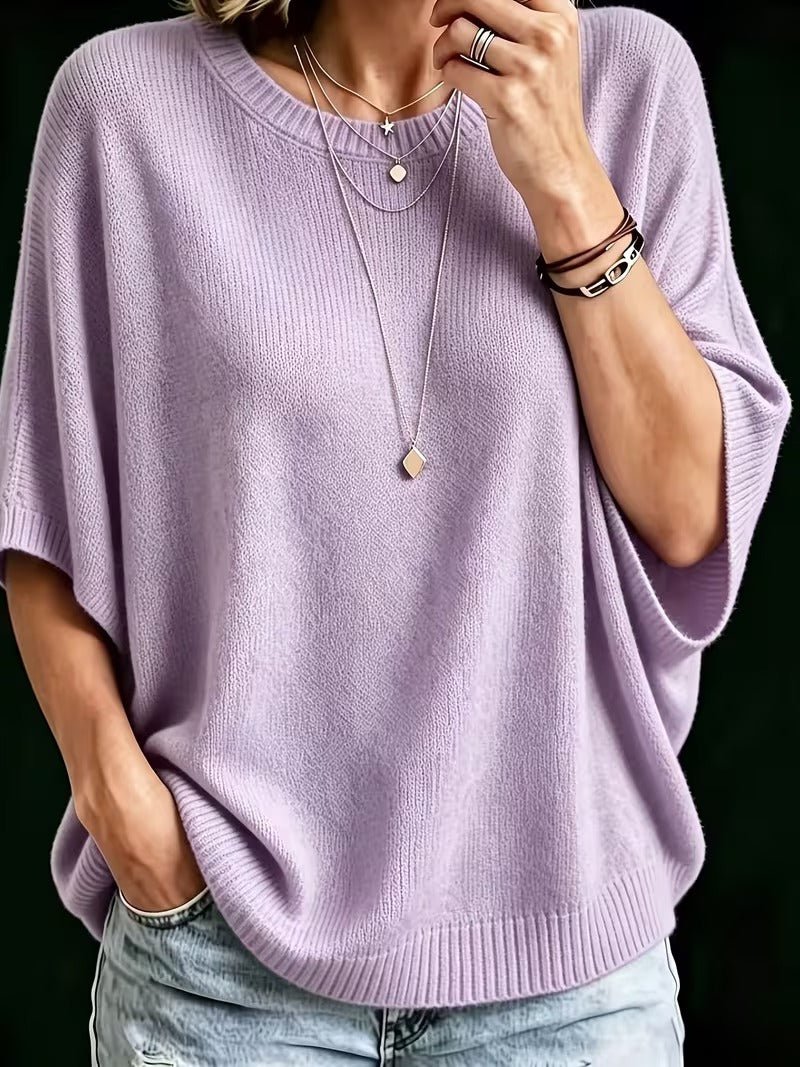 Close-up front view of the lilac batwing knit top with ribbed neckline, hem and cuffs, worn with layered necklaces. 7