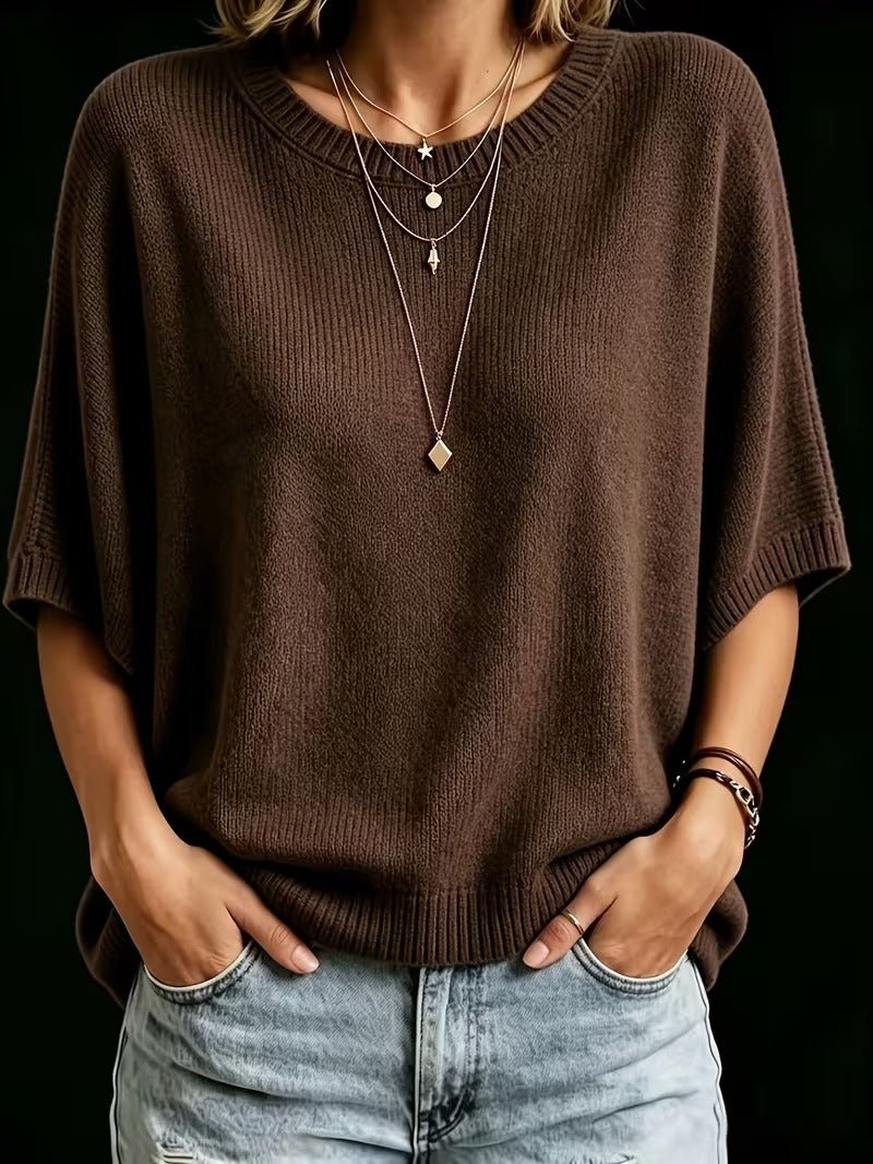 Front view of the dark brown knit top with both hands in jeans pockets, showing the loose batwing sleeves. 18