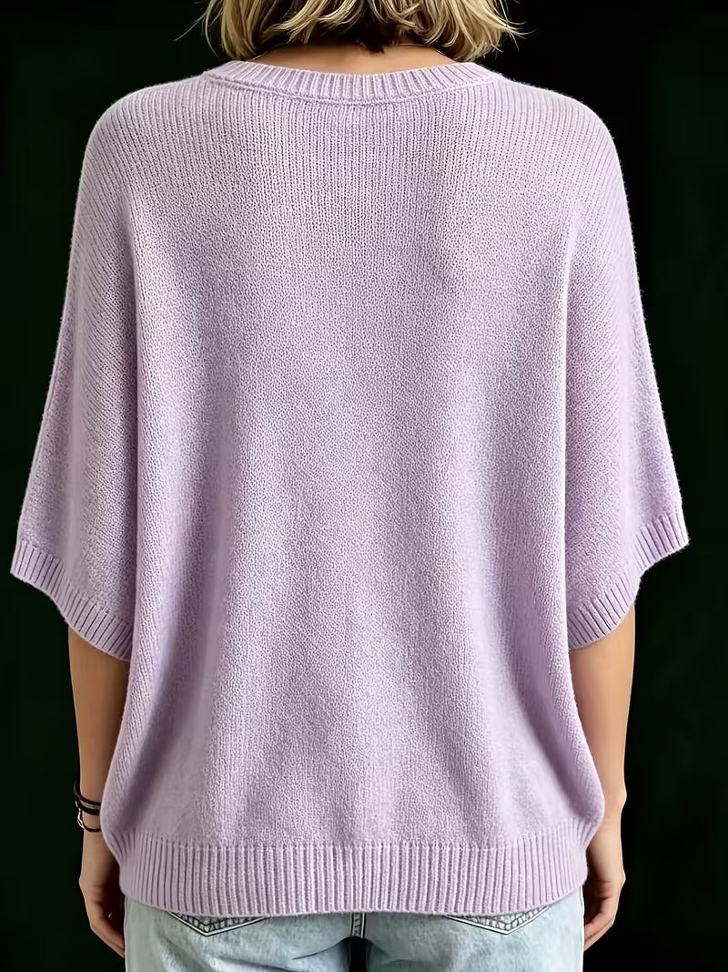 Back view of the lilac knit top on a model, showing the ribbed neckline, sleeve cuffs and hem. 9