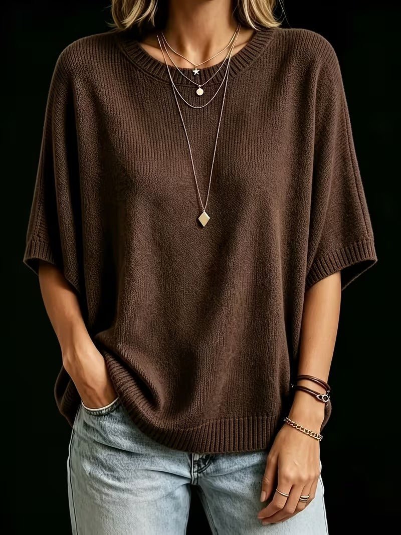 Dark brown knit top shown from the front with one hand in a pocket, worn with light jeans and bracelets. 19