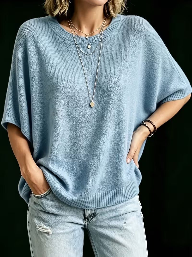Light blue knit top worn with one hand on the hip and one in a jeans pocket, showing the relaxed fit. 15