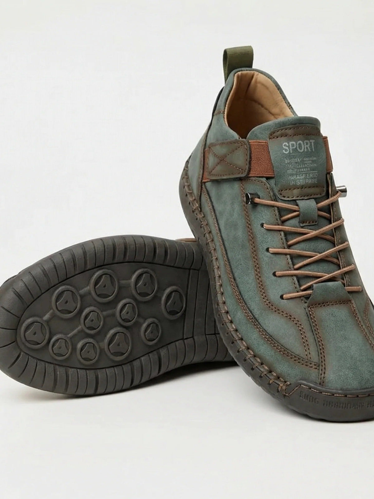 Green stitched trainers with elastic laces, one shoe resting on its side to show the dark studded sole 16