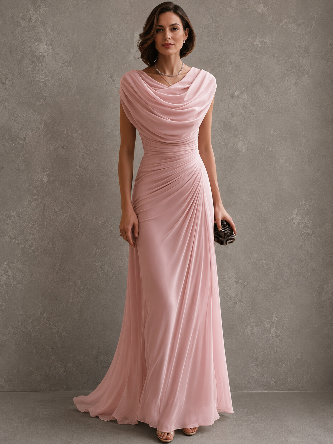 Full-length view of the dress in soft blush pink, worn by a model, showing the cowl neckline and gathered side ruching. 5