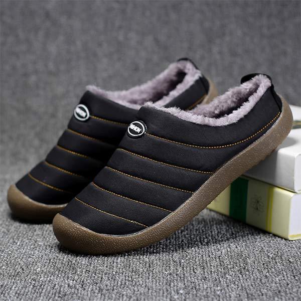 Pair of black quilted slippers with grey fleece lining, one resting on books 7