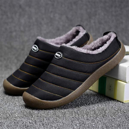 Pair of black quilted slippers with grey fleece lining, one resting on books 8