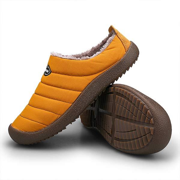 Mustard yellow slipper beside an upturned one revealing the brown tread pattern on the sole 11