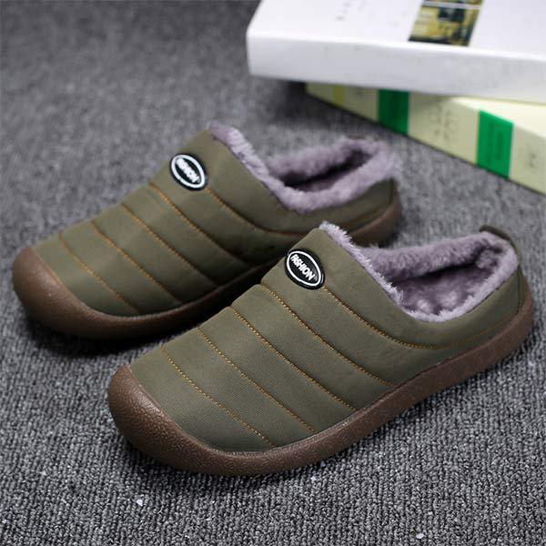 Olive green slip-on slippers with soft grey fleece collars, shown as a pair on carpet 2