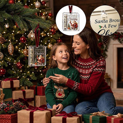Clear acrylic ornament with a rolled note hanging on a lit tree, as a mother and daughter in jumpers look on, with detail insets. 1