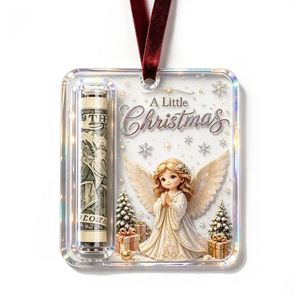 Ornament with a praying angel with cream wings among presents and snowy trees, with a rolled note in the side tube. 18