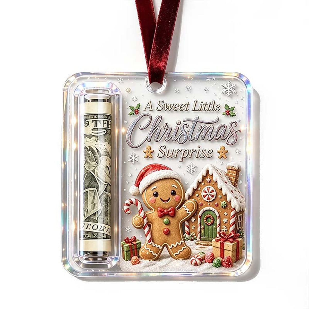 Ornament with a gingerbread man in a Santa hat beside a gingerbread house, with a rolled note in the side tube. 20