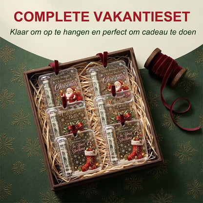Gift box lined with straw holding six acrylic ornaments in three designs, each with a rolled note, beside a ribbon spool. 7