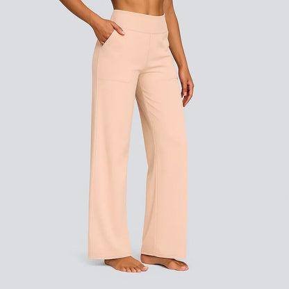 Soft peach version of the high-waist straight-leg trousers, side view of a barefoot model with hand in pocket. 14