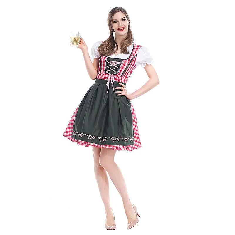 Model holding a beer mug wears the dirndl with red gingham bodice, white puff sleeves and a dark green apron, full-length front view. 1