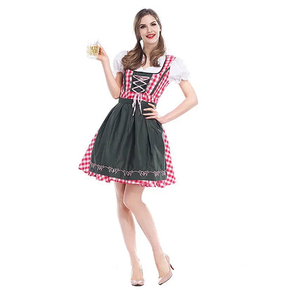 Model holding a beer mug wears the dirndl with red gingham bodice, white puff sleeves and a dark green apron, full-length front view. 1