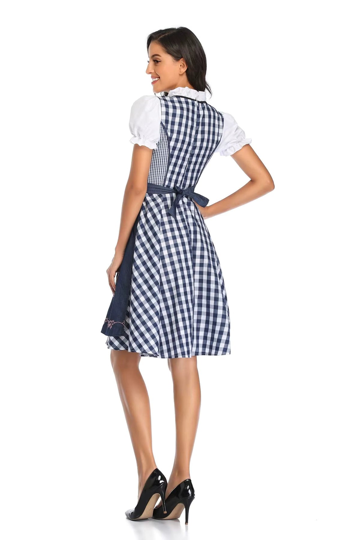 Back view of the navy and white check dirndl showing the zipped bodice, bow-tied navy apron and flared knee-length skirt. 6
