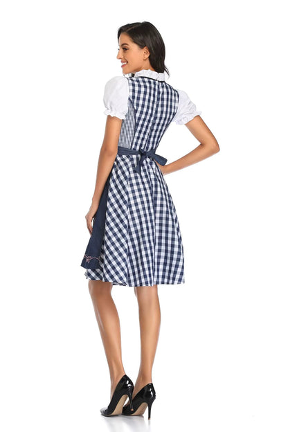 Back view of the navy and white check dirndl showing the zipped bodice, bow-tied navy apron and flared knee-length skirt. 6