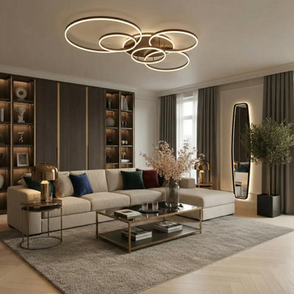 Ring light with warm glow hanging over a cream corner sofa, glass coffee table and tall mirror 3