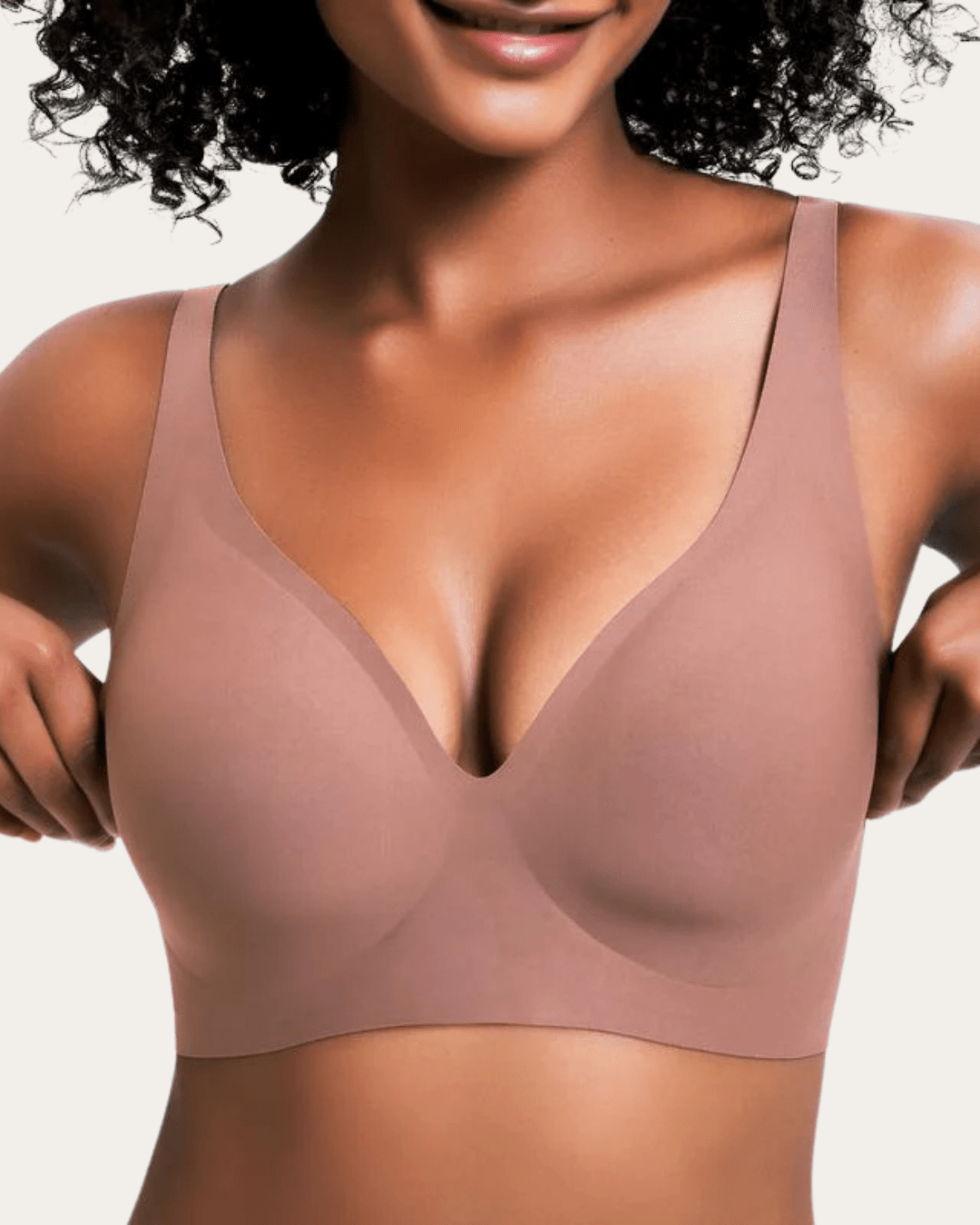 Model wearing the seamless bra in a dusky rose-brown shade, front view with smooth moulded cups. 8