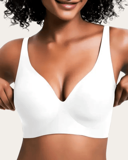Model wearing the seamless bra in plain white, front view with a smooth finish and wide straps. 7