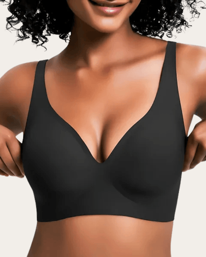 Model wearing the seamless bra in plain black, front view showing the deep V neckline and wide straps. 9
