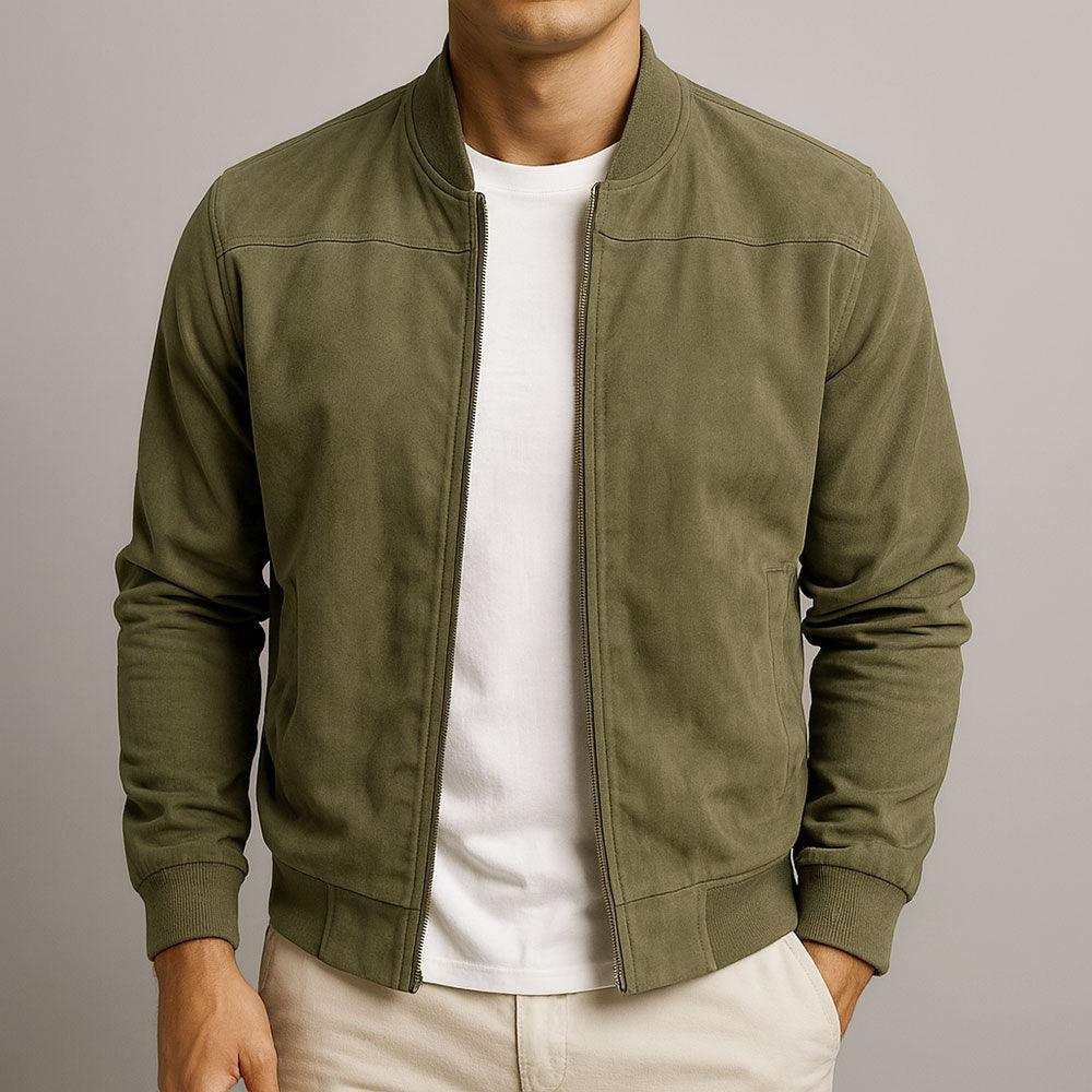 Model wearing the jacket in olive green, zipped partly open over a white t-shirt, with seam detail across the shoulders. 3