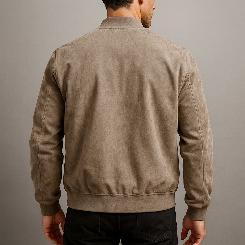 Back view of the jacket in taupe, showing the smooth panel, ribbed collar, hem and cuffs, worn with black jeans. 7
