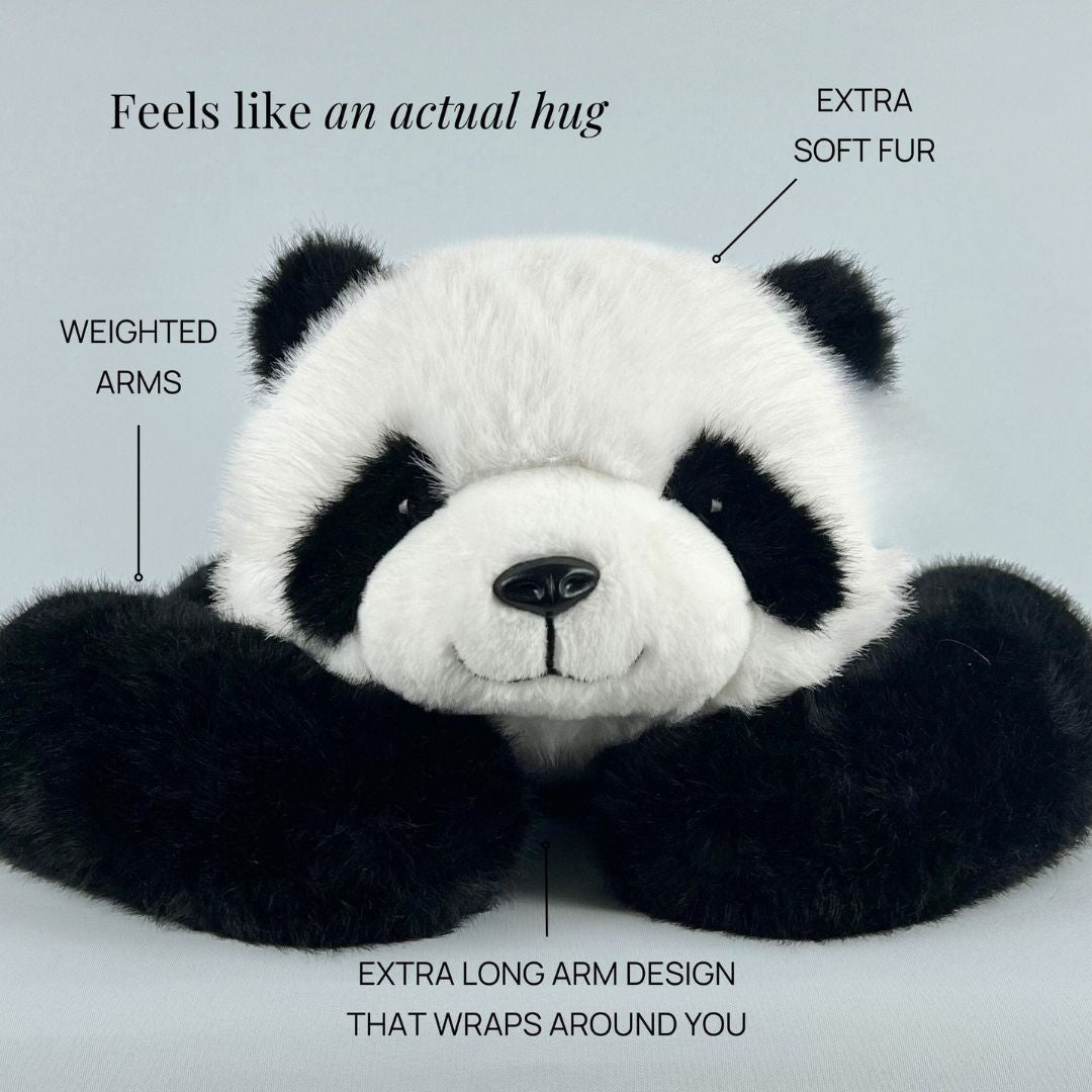Close front view of the panda plush resting its head on its long, weighted black arms, with callouts pointing to its features. 5