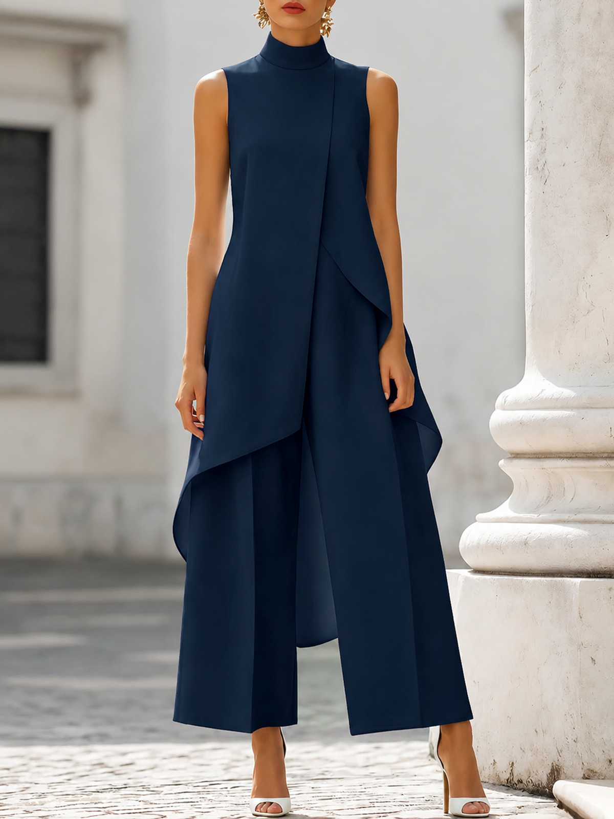 Front view in navy blue on a model by a stone column, showing the sleeveless funnel-neck top and wide-leg trousers. 6